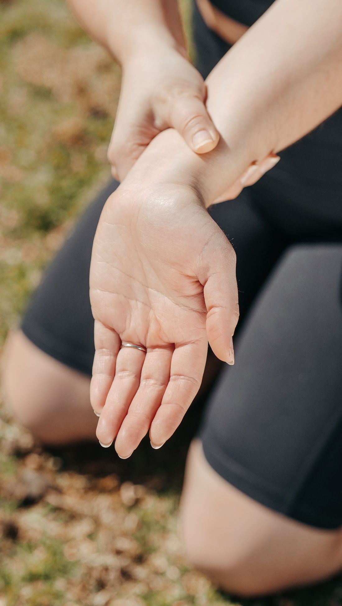 Person holding their wrist, indicating wrist pain